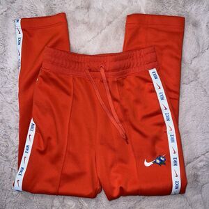 Nike Women’s Sportswear track pants light crimson/white floral accents XS